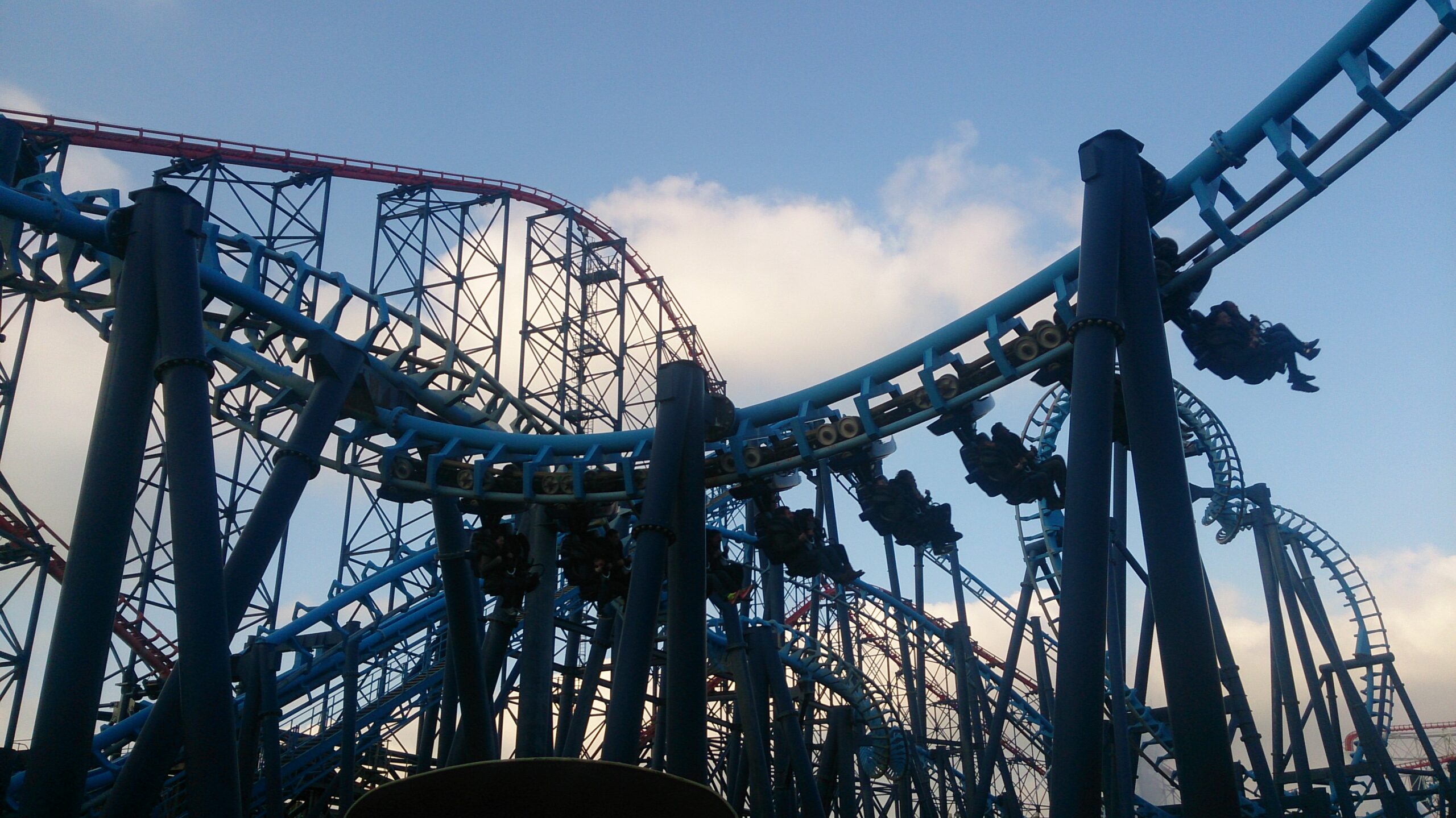 Image of Infusion at Blackpool Pleasure Beach with train on track, and Big One in the background